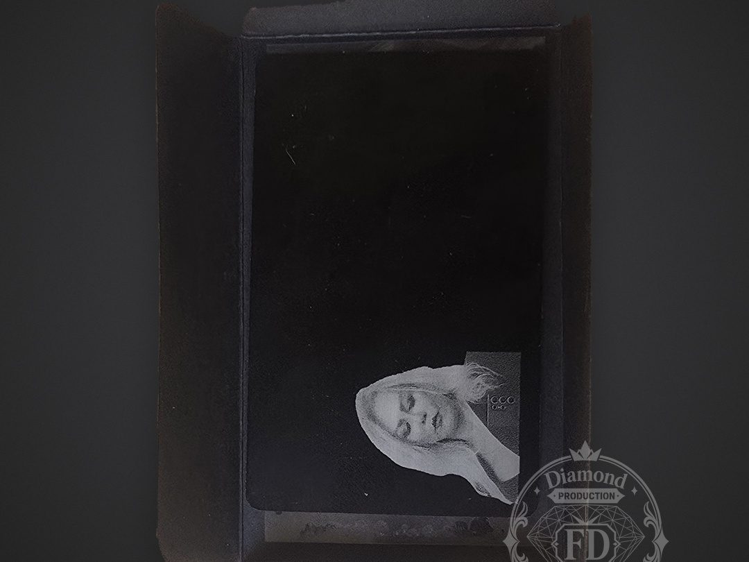 Engraved metal card resting inside an open black gift box
